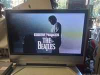 Front view of Panasonic Viera plasma TV displaying a scene with text 'Executive Producers The Beatles' indicating it is functioning.
