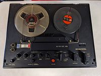 Top view of UHER SG 560 Royal tape recorder with tape reels loaded, control panel with buttons and knobs visible
