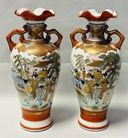 Pair of 10-inch Japanese vases with hand painted traditional scenes, front view showing detailed artwork and shape