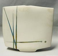 Front view of rectangular ceramic vase with abstract linear design in blue, green, and black on cream background.