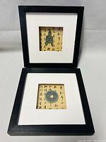 Close-up view of the two Neu Home Zen Chinese coin shadow box sets, showing the different coin designs and frame style.