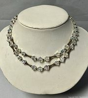 Double strand crystal bead choker displayed on necklace stand showing the bead pattern and clasp details.