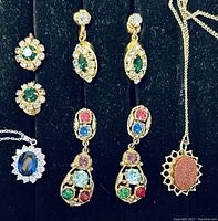 Top view of clip-on earrings and necklaces showing details of stones and settings