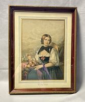 Full view of framed print showing the image of a young woman holding a basket of fruit with the frame around.