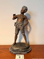 Front view of figurine on base showing overall shape