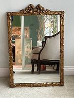 Full front view of rectangular mirror showing ornate carved gilt frame