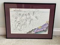 Full framed view of pastel and pencil artwork with maroon mat and black frame leaning against wall