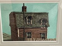 Close-up of house facade showing mansard roof, arched windows, fence and sky