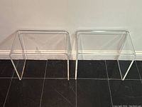 Front view of both clear acrylic end tables side by side