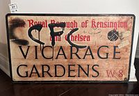 Full view of the metal street sign showing text, border, and overall wear