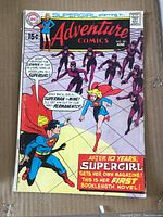 Front cover of Adventure Comics No. 381 showing Supergirl and Superman with various characters and text highlighting Supergirl's first booklength novel.