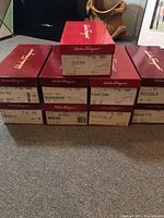 Stack of original Salvatore Ferragamo boxes showing model names and size labels