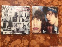 Two vintage Rolling Stones bubble gum records with original shrink-wrap, featuring color and black & white album art.