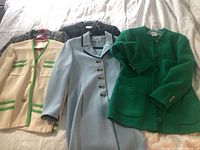 Four women's designer jackets displayed side by side