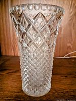 Front view of eight inch clear crystal vase showing detailed diamond lattice cut pattern and scalloped edge rim.