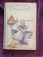 Front cover of vintage German adolescent book Pommerle by Magda Trott, showing illustrated girl sitting on a boat near water with sailboats in background.