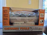 Photo of boxed Ceramic Tools Porcelain Plus Instant Heat 12 Roller Set showing commercial grade porcelain ceramic hot rollers with product branding and features.
