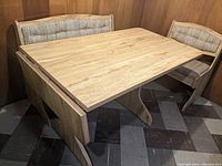 Corner laminate dining table with fold-up extension, long storage bench and short storage bench, viewed from corner angle showing upholstery and table surface.