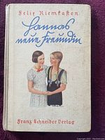 Front cover of a 1934 German hardcover novel with illustrated cover artwork showing two girls and text in script.