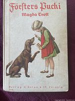 Front cover of the book showing title, author, and a colored illustration of a girl with a dog.