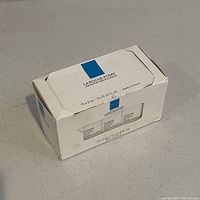 Front and top view of unopened white box of La Roche-Posay Double Repair Face Moisturizer showing blue logo and 15 x 3ml size labeling.