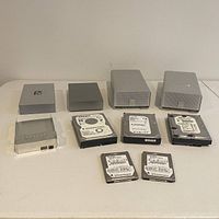 Full view of all hard drives and enclosures arranged on table.