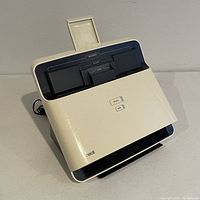 Front view of the white NeatDesk document scanner showing scan and PDF buttons and document feeder.