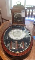 Photo showing both mantel and oval wall clock side by side