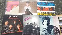 All six records arranged on ground, covers visible showing wear and different titles and artists.