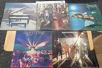 Five records laid out showing the front cover artworks of Supertramp, Heart, Nazareth, The Guess Who, and one more Supertramp album.
