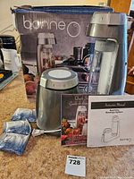 Bonne O sparkling beverage system with the main machine, carbonating bottle, manuals, and 3 new carbonators displayed on a countertop alongside the product box.