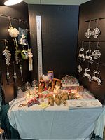 Full display of all Christmas ornaments and decorative items on table with black backdrop.