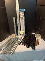 Drawer guides and drawer slide rails spread on table with ruler for measurement