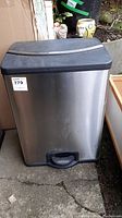 Full view of the rectangular stainless steel trash bin with a closed lid and foot pedal at the base.
