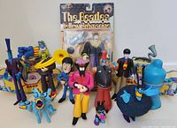 Front view of multiple Beatles Yellow Submarine figures with one in original packaging.