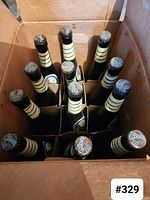 Top view of twelve unopened Coors Light beer bottles in cardboard box.