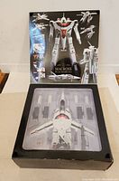 Opened box showing VF-1A aircraft and accessories in plastic tray