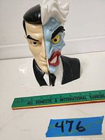 Front view of the Two-Face bookend showing the two sides split down the middle with ruler for scale, about 6 inches tall.