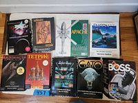 Top-down view of all 9 boxed PC CD-ROM games, showing front cover art with colorful illustrations including helicopters, airplanes, puzzle pieces, and characters.