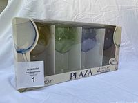 Boxed set of four Plaza balloon red wine glasses, four different colors, unopened in original packaging with slight wear to box.