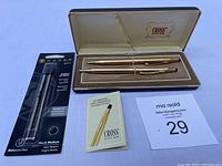 Full view of the pen and pencil set in original box with two replacement pen cartridges in sealed packaging and guarantee booklet.