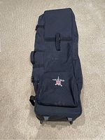 Front view of black canvas golf bag case with KODAK logo on a front pocket, showing exterior details and structure.