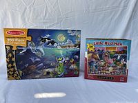 Photo showing both puzzle boxes: Melissa & Doug Underwater Playground 200-piece and Dowdle Little Red Hen 100-piece.