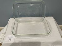 Two clear rectangular Pyrex glass baking dishes stacked, showing size and shape.