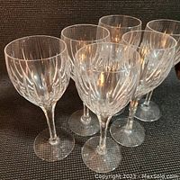 Six goblets arranged showing fluted pattern and tall stems