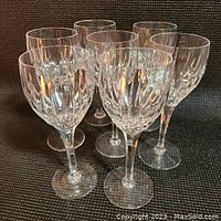 Front view of seven wine glasses arranged in a cluster showing Monaco pattern fluted cuts