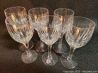 Six wine glasses arranged in two rows, front view