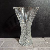 Side view of the 9-inch tall vintage cut crystal vase showing diamond pattern on the lower body and clear vertical cuts on the upper portion with a flared rim.