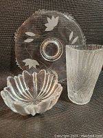 Photo of Wedgwood bowl in front, crystal vase and glass platter in background, showing general condition and crack in bowl base.