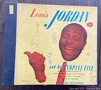 Front cover of Louis Jordan and His Tympany Five 78 RPM album showing artwork and title.
